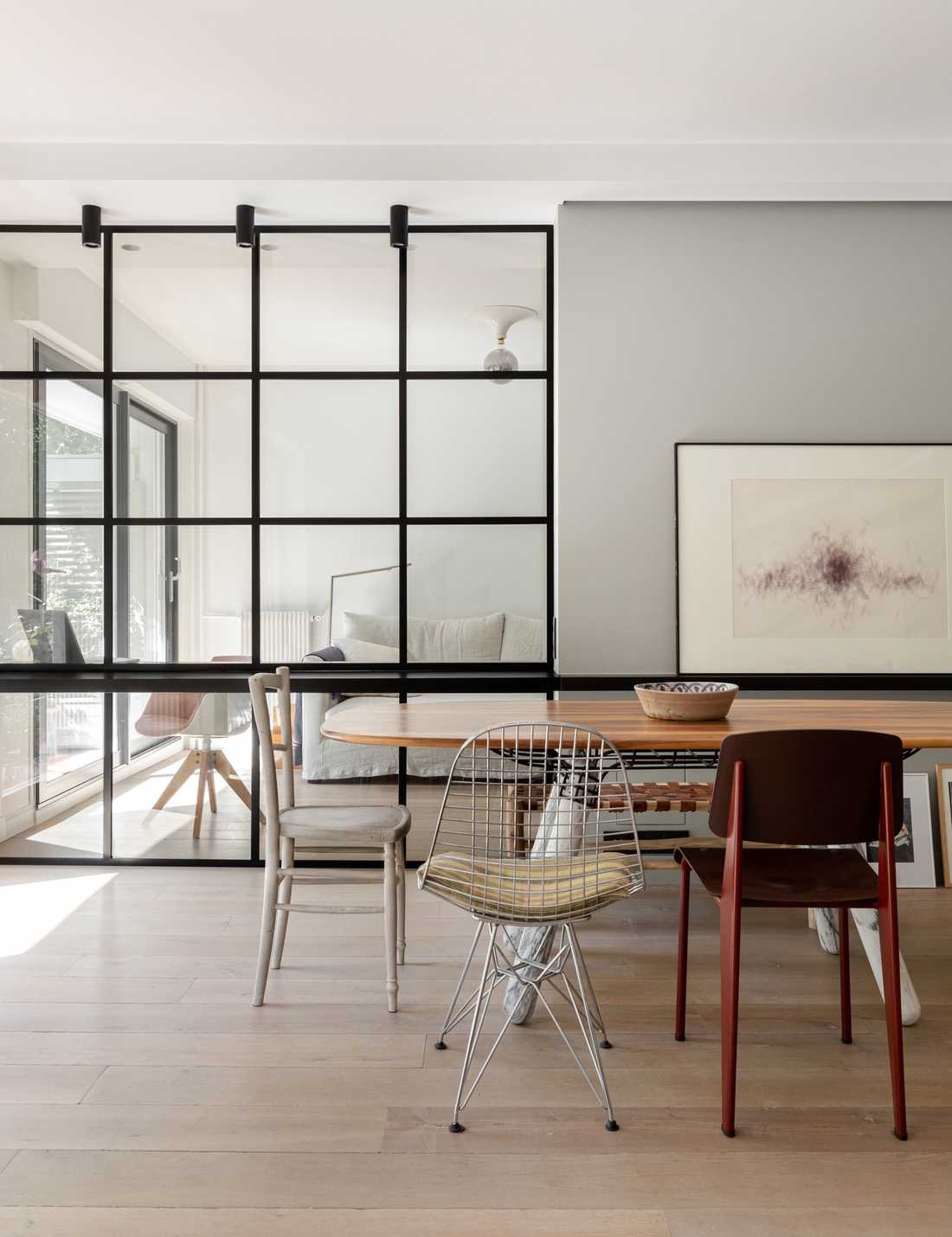 Custom-made glass roof between bedroom and living room designed by an interior designer